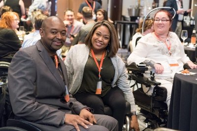 People in wheelchairs smiling at camera