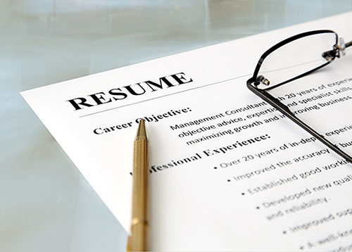 Image of a pen and glasses on a Resume