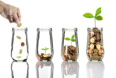 hand dropping coins into 4 vases, in which plants are growing