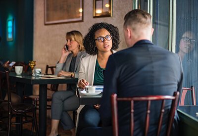 woman and man talking at a cafe