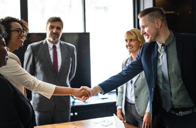 man and woman shaking hands during an interview