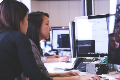 two women looking at computer screen