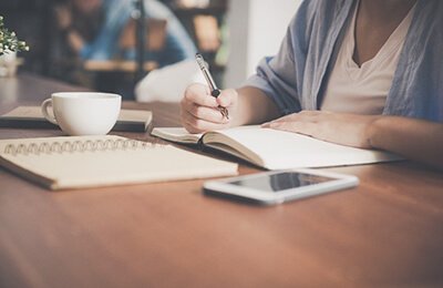 Person at desk writing