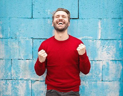 smiling man in red sweatshirt