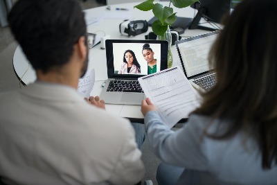 Four professionals collaborating over a video connection