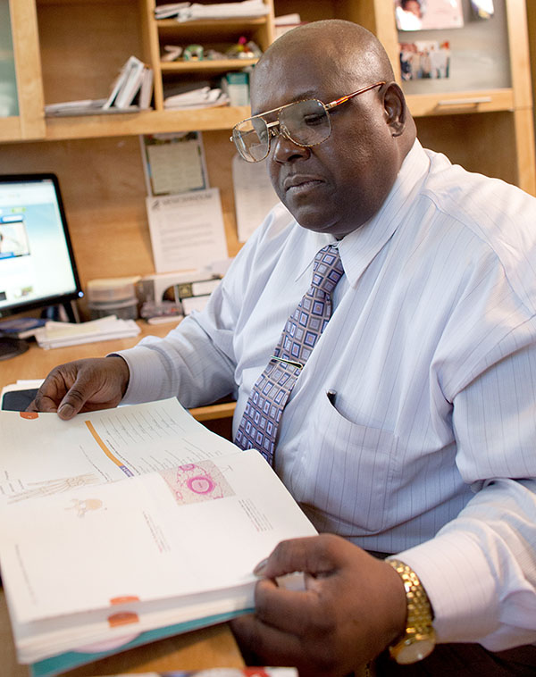 Picture of Robert sitting at desk reading a book