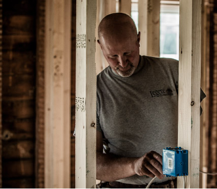 Photo of Marty installing electrical wiring