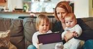 mother and children looking at a tablet